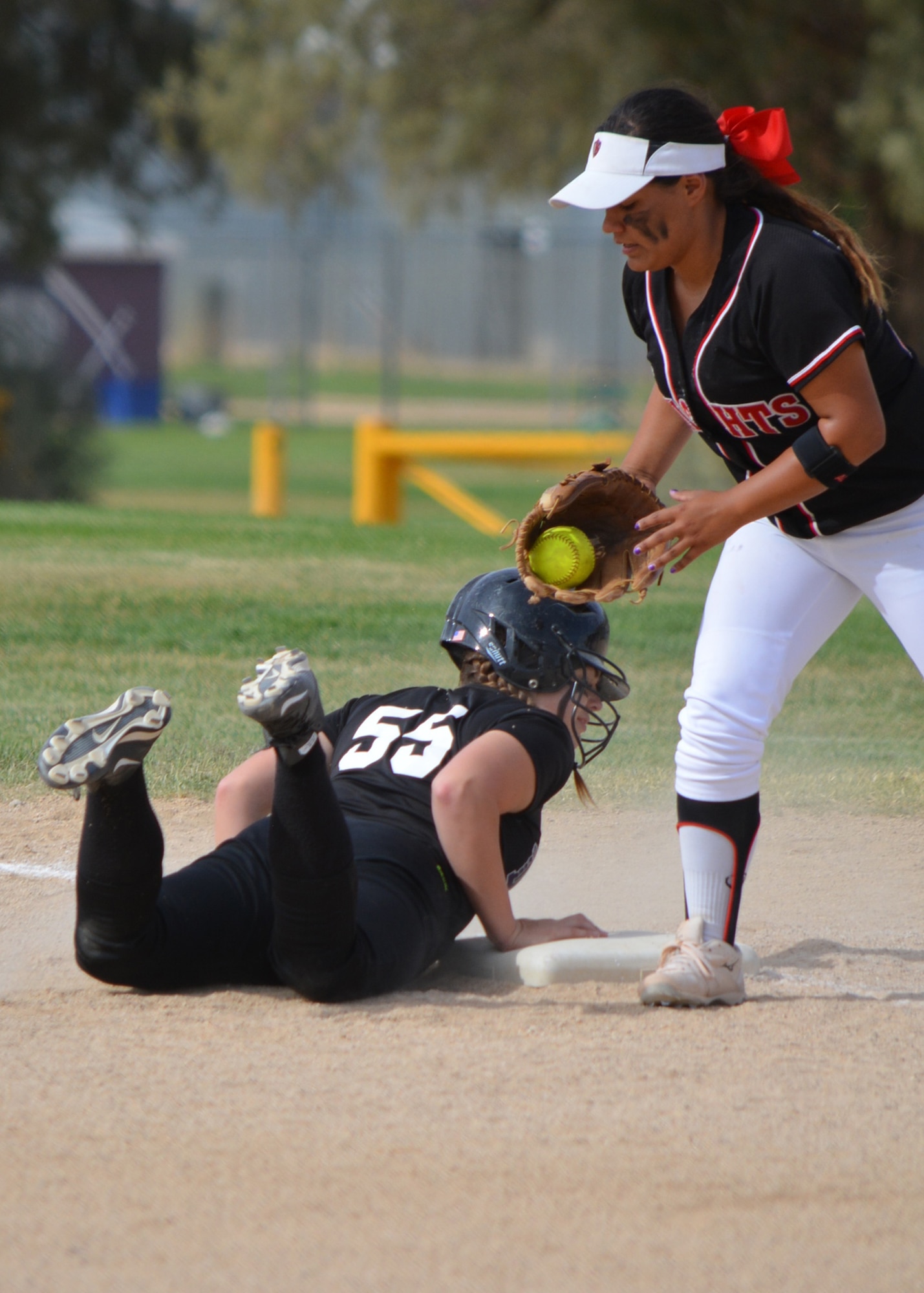 Senior Victoria Rush, from Desert High School, dives back to first to avoid being thrown out during the second round game of the CIF-Southern Section Division 6 playoffs May 26 at DHS. The DHS team finished 15-9 in the regular season. (U.S. Air Force photo by Kim Lathrop)