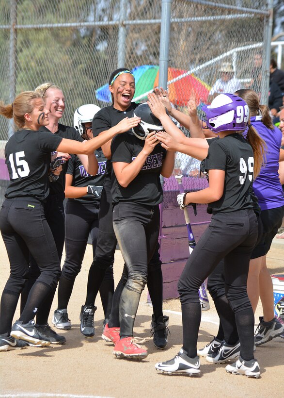 Senior Katee Boyer, from Desert High School, gets congratulated from her teammates after an inside-the-park home run against Katella High School (Anaheim) during the second round game of the CIF-Southern Section Division 6 playoffs May 26 at DHS. Although the DHS Softball team seemed like they would advance to the quarterfinals, Katella was able to edge the Scorpions out in the 11th inning. The DHS team finished 15-9 in the regular season. (U.S. Air Force photo by Kim Lathrop) 