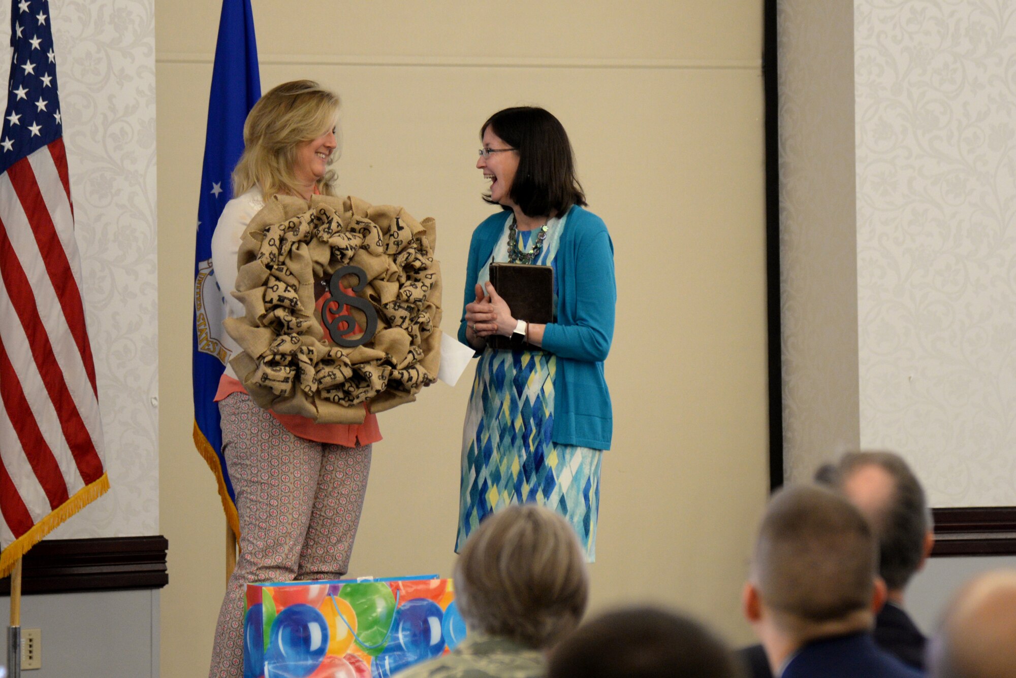 Deb Kremer presents a gift to Keynote Speaker Ricki Selva at the Key Spouse Appreciation Luncheon May 19, 2015 at the Scott Club, Scott Air Force Base, Illinois. The luncheon was hosted to show appreciation and gratitude to key spouses. Kremer is the wife of Col. Kyle Kremer, 375th Air Mobility Wing Commander, and Selva is a wife of Gen. Paul Selva, Transportation Command Commander. (U.S. Air Force Photo by Airman 1st Class Megan Friedl)