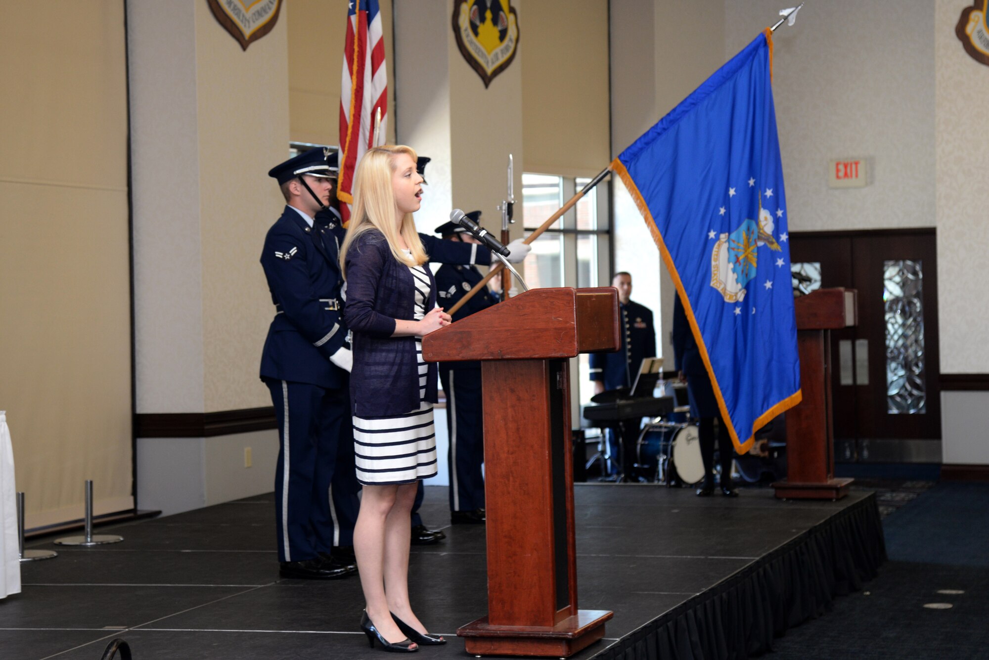 Claire Grooms sings the National Anthem at the Key Spouse Appreciation Luncheon May 19, 2015, at the Scott Club, Scott Air Force Base, Illinois. The luncheon was hosted to show appreciation and gratitude to key spouses. (U.S. Air Force Photo by Airman 1st Class Megan Friedl)