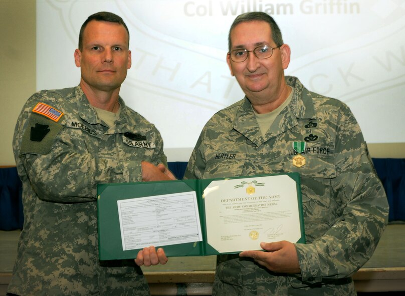 Maj. George Moebius, 56th Stryker Brigade Combat Team, 28th Infantry Division, Horsham Air Guard Station, Pennsylvania,  presents Senior Master Sgt. John Hertler of the 111th Attack Wing with the Army Commendation Medal by for his participation in Pa. Army National Guard’s Vigilant Guard exercise from May 10 – 15 last year, May 21, 2015, in the wing headquarters building, Horsham AGS. The 56th SBCT is one of nine Stryker Brigade Combat Teams in the United States Army and one of five brigades of the 28th Infantry Division. (U.S. Air National Guard photo by Tech. Sgt. Andria Allmond/Released)