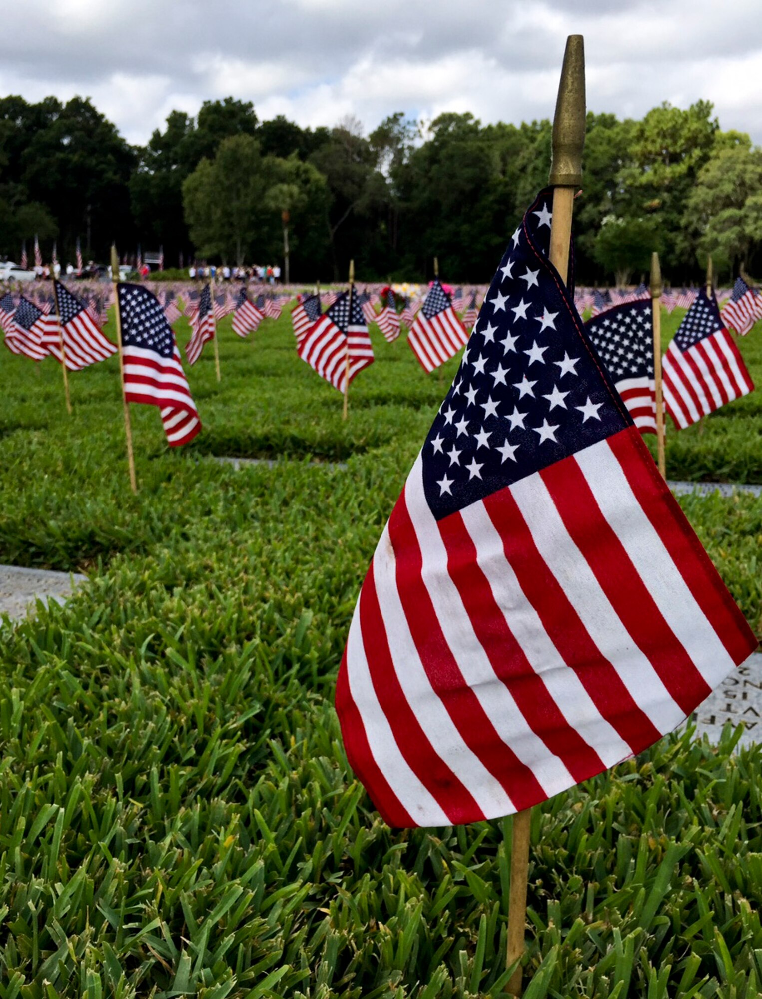 American flags were placed in front of headstones in honor of Memorial Day at Florida National Cemetery in Bushnell, Fla., May 24, 2015. Memorial Day is a day of remembrance for those who have died while serving in the armed forces. (U.S. Air Force photo by Senior Airman Bulow-Gonterman/Released)  