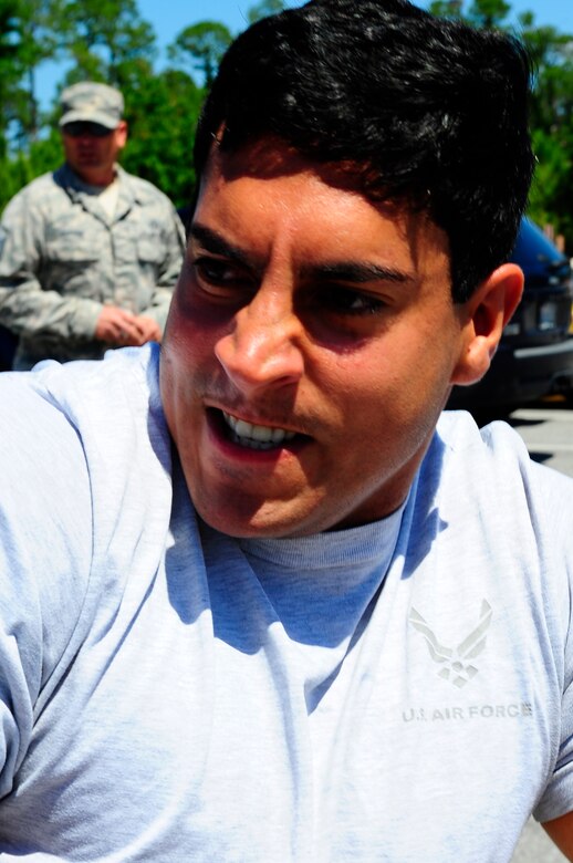 Senior Airman Jonathan Melendez, 2nd Combat Weather System Squadron weather systems instructor, pulls a fire truck for fitness day at Hurlburt Field, Fla., May 6, 2015. Air Force Fitness Month promotes physical wellness and teaches Airmen how being "fit" plays a vital role in the quality of military life. (U.S. Air Force photo/Airman 1st Class Andrea Posey)