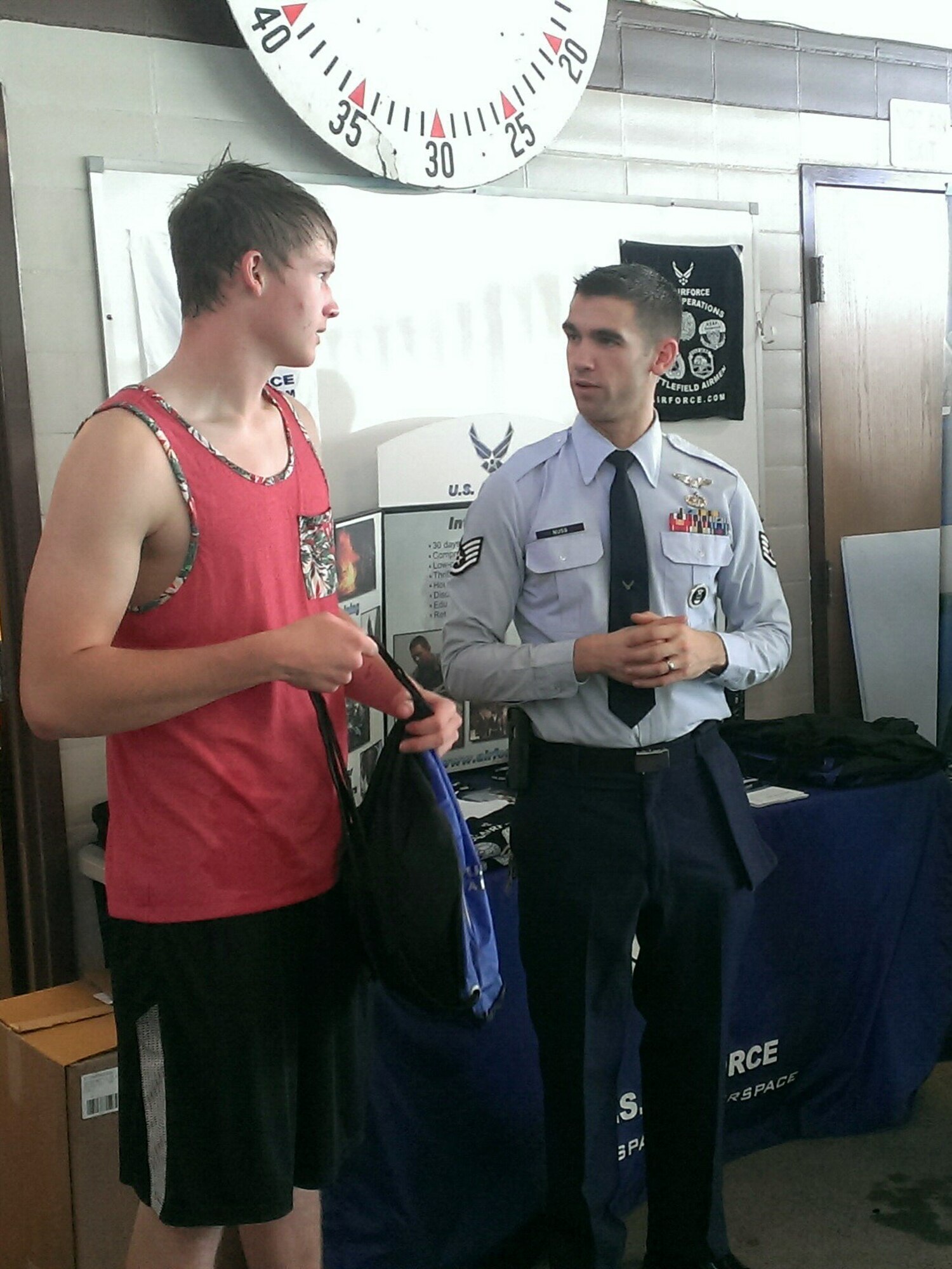 Staff Sgt. Zachary R. Nuss speaks to a potential applicant at a recent swim meet in his zone. Nuss is assigned to the 361st Recruiting Squadron F-Flight in North Bend, Oregon. (U.S. Air Force photo)