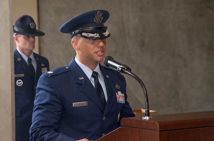 Col. Michele Edmondson, 737th Training Group commander, passes the guidon to Lt. Col. Gedeon Mariam during the 321st Training Squadron change of command ceremony May 27, 2015, at Joint Base San Antonio-Lackland, Texas. The passing of the guidon marks the beginning of Mariam’s tour as commander of the321st TRS. He will be responsible for the basic military training of nearly 7,000 Airmen each year and all aspects of personnel management and professional development for 65 assigned military training instructors and administrative staff. (U.S. Air Force photo by Johnny Saldivar/released)