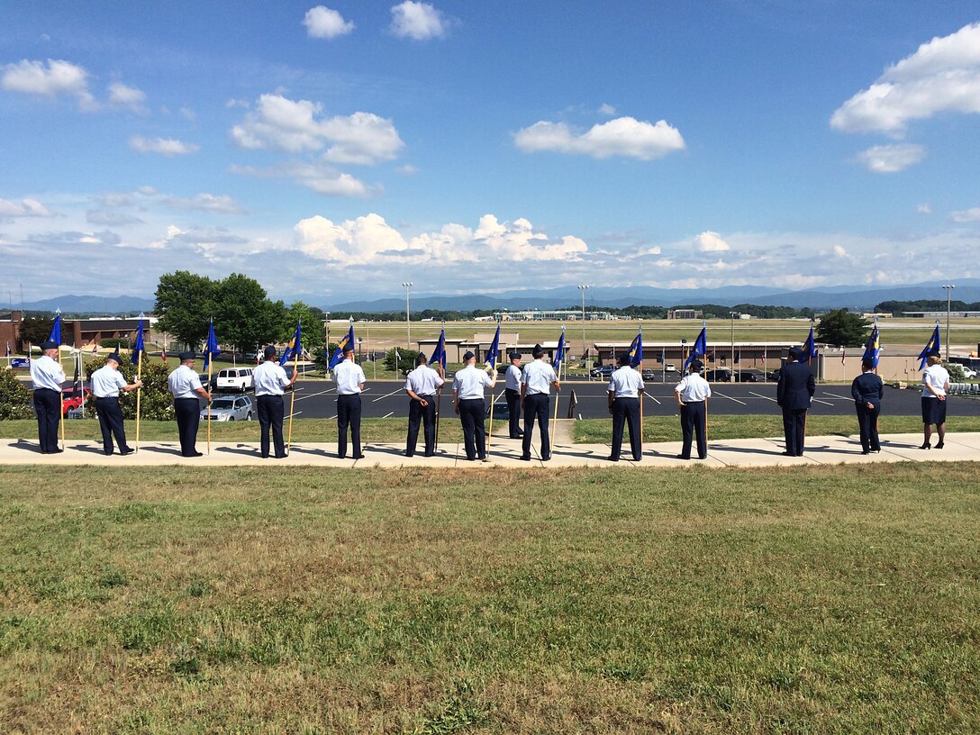 MCGHEE TYSON AIR NATIONAL GUARD BASE, Tenn. - With the Great Smoky Mountains in the foreground, Master. Sgt. Richard Rose, instructor for the Paul H. Lankford Enlisted PME Center, coaches U.S. Air Force NCO academy students here May 27, 2015, on how to carry the guidon flags for their student flights at the I.G. Brown Training and Education Center.  The students began the six-week academy Tuesday. (U.S. Air National Guard photo by Master Sgt. Mike R. Smith/Released)