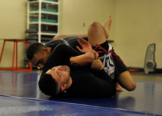 Airman 1st Class Solomon Cook, 325th Fighter Wing public affairs specialist (Bottom), practices technique and submissions with Senior Airman Trey Cooke, 325th Civil Engineering Squadron fire fighter, April 2 at the Tyndall Fitness Center during a SAMozashchita Bez Oruzhiya or SAMBO class. The fitness center has various fitness classes including SAMBO available for those with access to the base. (U.S Air Force photo by Airman 1st Class Sergio Gamboa/Released)