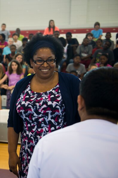 Luva Herman, Pine Grove Middle School physical science teacher, speaks with an Afghan air force pilot after giving him a T-shirt May 20, 2015, at Pine Grove Middle School in Valdosta, Ga. Herman thanked the pilot for preparing her entire class qabili palau, Afghanistan’s national dish. (U.S. Air Force photo by Airman 1st Class Dillian Bamman/Released)