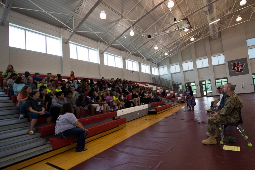 Afghan air force pilots and 81st Fighter Squadron members prepare for a Q-and-A event with students May 20, 2015, at Pine Grove Middle School in Valdosta, Ga. The pilots and service members toured the school with Luva Herman, Pine Grove Middle School physical science teacher, before hosting the event. (U.S. Air Force photo by Airman 1st Class Dillian Bamman/Released)