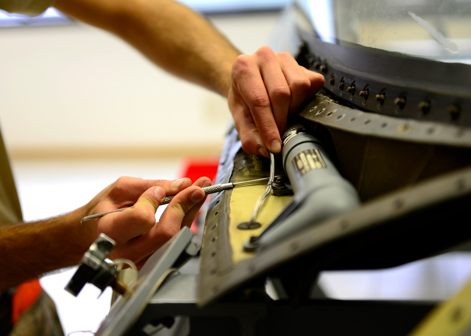 A U.S. Airman assigned to the 31st Maintenance Squadron aircrew egress systems shop, ensure all the mechanical components function properly, May, 27 2015, at Aviano Air Base, Italy. Aircrew egress systems technicians maintain aircraft egress components to ensure pilots can safely exit their airplane, should the unthinkable happen. (U.S. Air Force photo by Senior Airman Areca T. Wilson/Released))