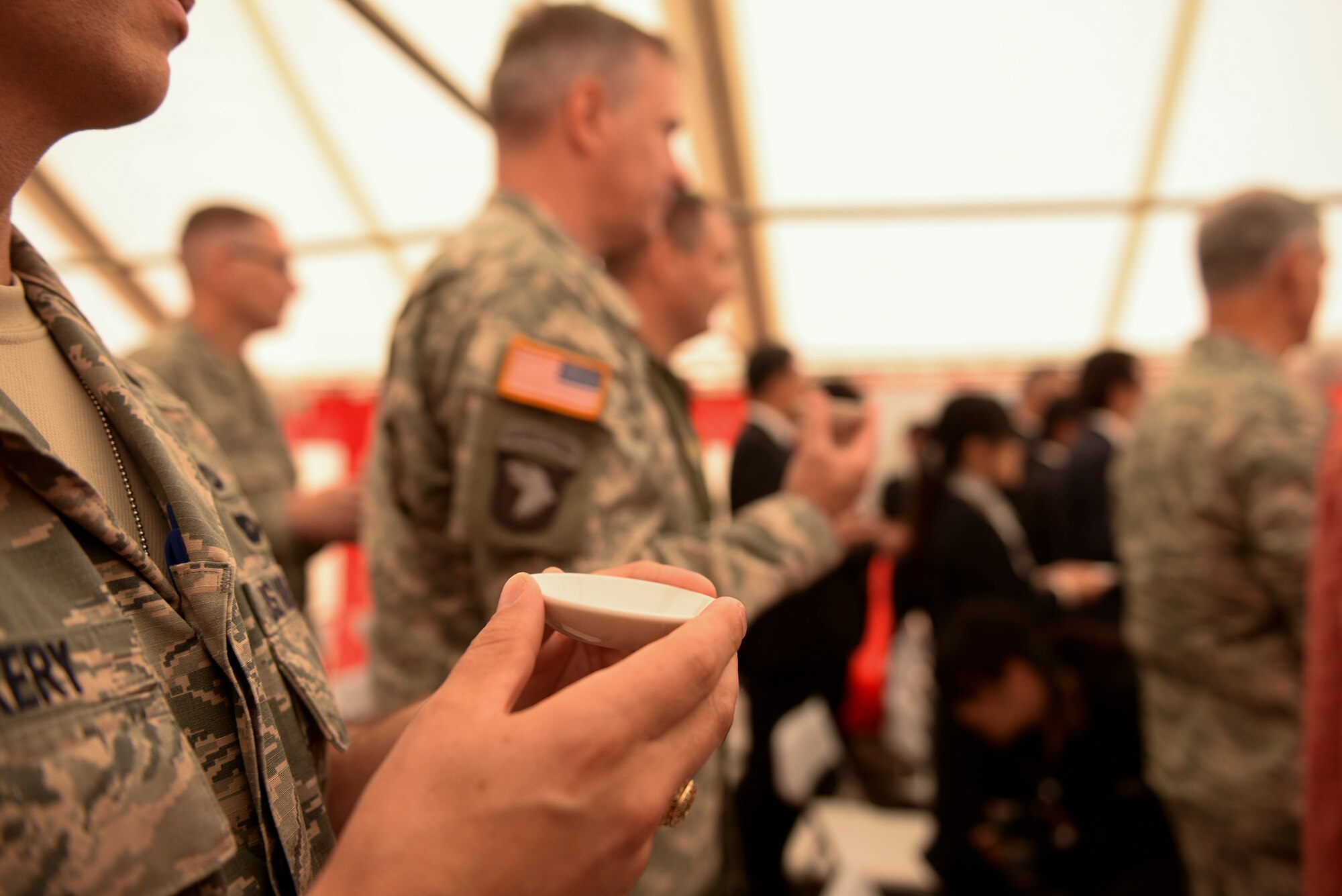 Distinguished guests at the ground breaking ceremony for the new Yokota High School hold omiki, ceremonial sake offered to the gods at Yokota Air Base, Japan, May 19, 2015. Shintoism is a religion originating in Japan which has been practiced for over 2,500 years.