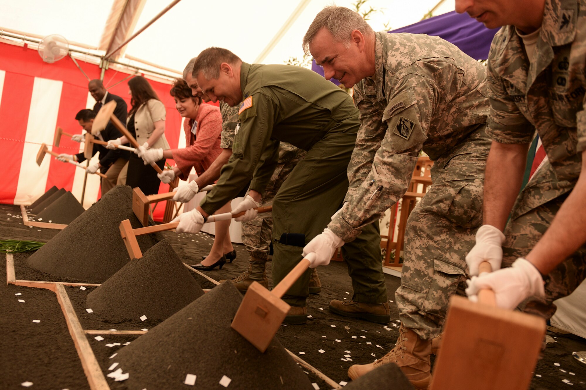Participants perform the ceremonial ground breaking ceremony for the new Yokota High School at Yokota Air Base, Japan, May 19, 2015. The new school is intended to accommodate 325 students and span 93,120 square feet. 