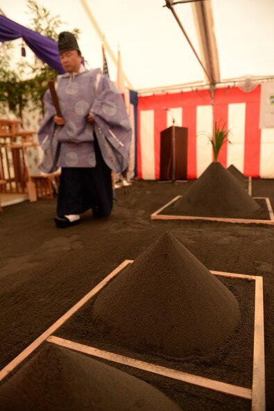 A Shinto priest carries a ritual shaku baton for driving out spirits during the new Yokota High School ground breaking ceremony at Yokota Air Base, Japan, May 19, 2015. The purpose of the Shinto ceremony is to purify the site of the new building and wish safety on the construction crew. 