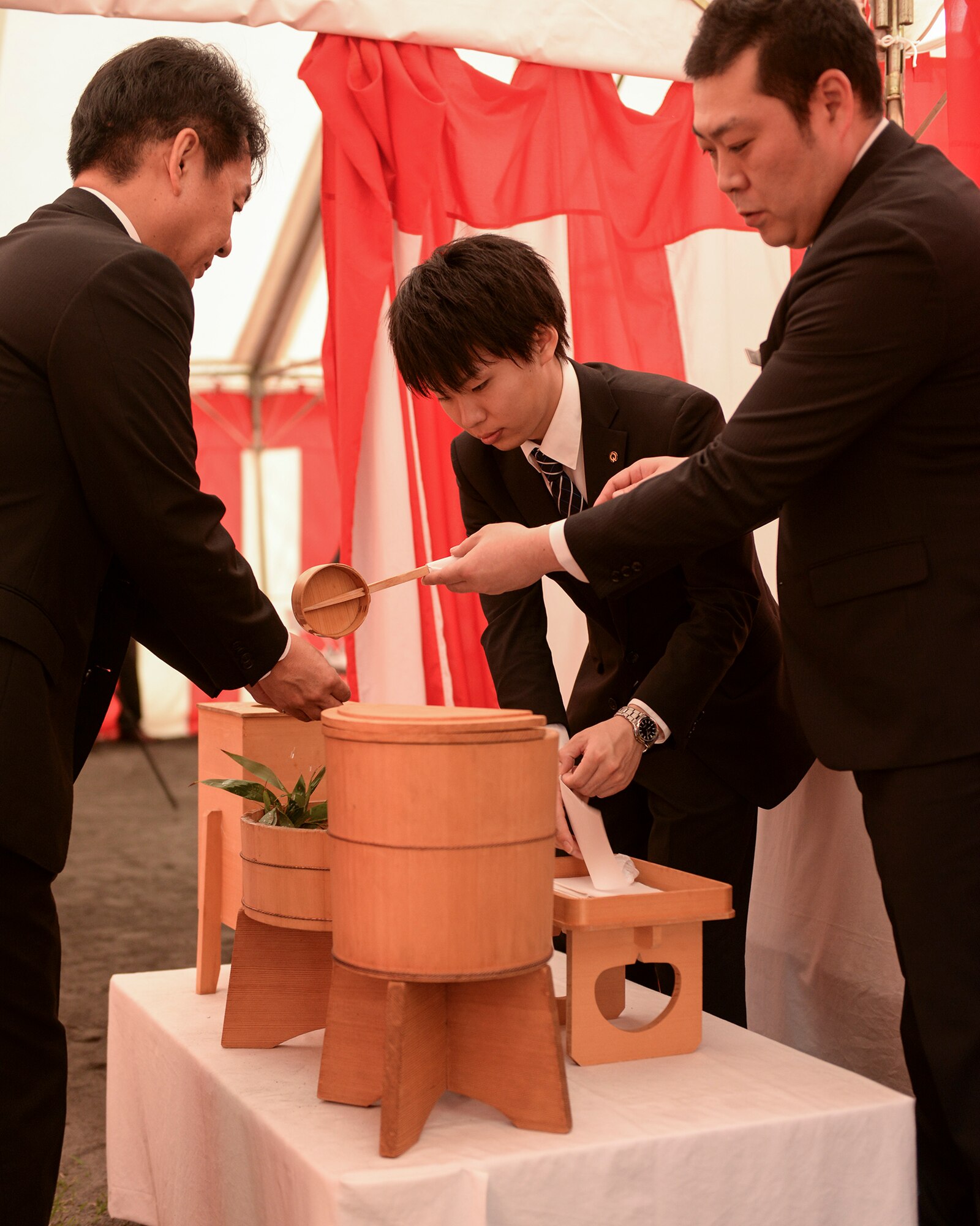 A participant at the new Yokota High School ground breaking ceremony washes his hands before entering the tent where the ceremony was held at Yokota Air Base, Japan, May 19, 2015. Everyone who entered the tent was required to wash first their left, then their right hand in observance of Shinto traditions. 
