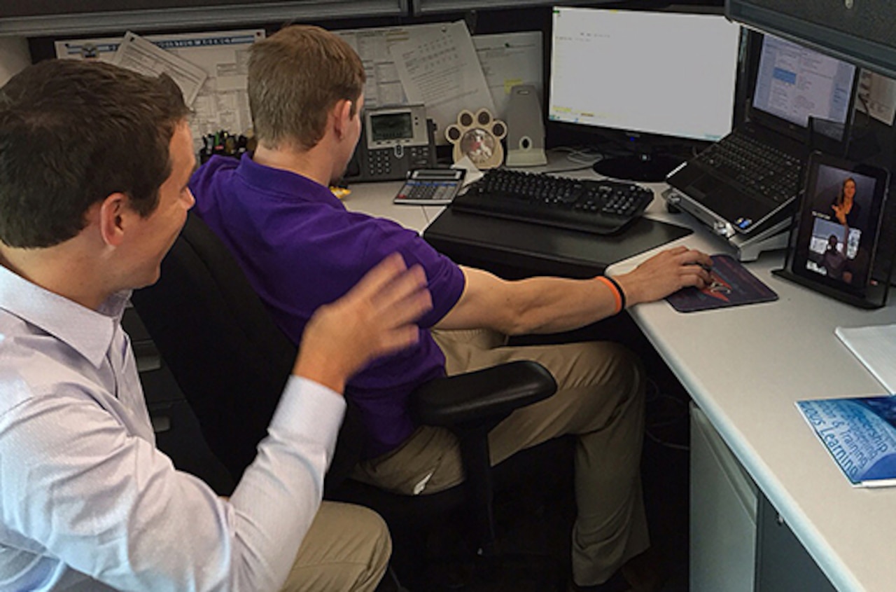 John Slone, left, and Jon Mowl of Defense Logistics Agency Finance use the virtual remote interpreting service via tablet. The service is being tested at DLA Headquarters at Fort Belvoir, Va., as a tool to improve communication for deaf employees. DoD photo by Debra Simpson