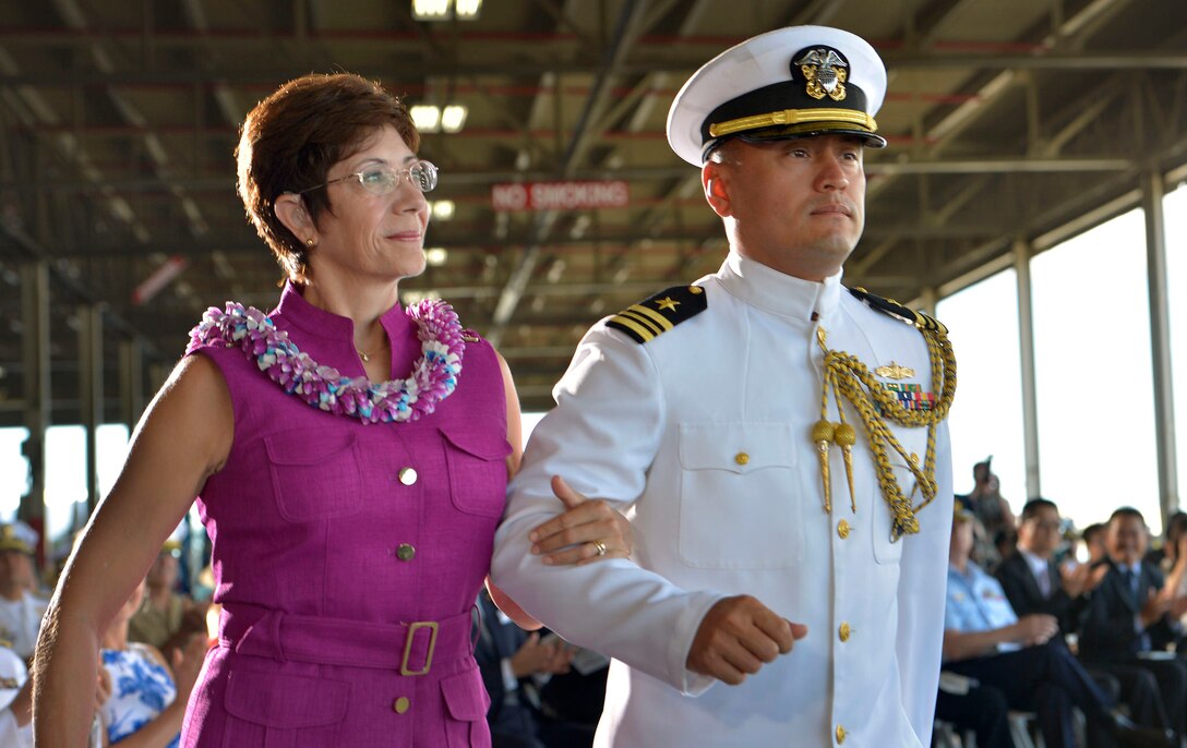 Pamela Locklear, wife of outgoing U.S. Pacific Command Commander Navy Adm. Samuel J. Locklear, III, is escorted to the stage to be recognized by Defense Secretary Ash Carter during the change-of-command ceremonies for U.S. Pacific Command and U.S. Pacific Fleet in Honolulu May 27, 2015. 