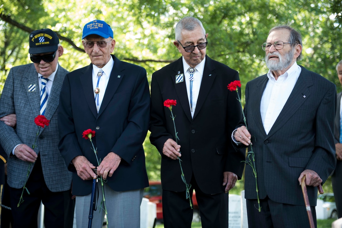 World War II veterans who fought with the 3rd Infantry Division, from left, John Miller II, John Keller, Robert Dutil and William Weinberg gather to place flowers at Audie Murphy’s gravesite at Arlington National Cemetery Arlington, Va., May 28, 2015. 