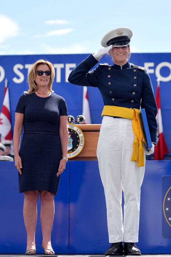 Rebecca Esselstein, the top cadet in the U.S. Air Force Academy's Class of 2015, salutes after receiving her diploma from Air Force Secretary Debrorah Lee James, left, during  graduation ceremonies at Falcon Stadium in Colorado Springs, Colo., May 28, 2015. 