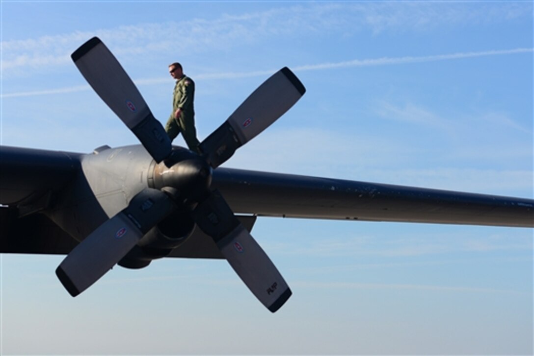 An airman walks on the wing of an AC-130H Spectre gunship during a preflight inspection on Cannon Air Force Base, N.M., May 27, 2015. The airman is assigned to the 16th Special Operations Squadron. The aircraft was the last AC-130H in the squadron’s fleet.