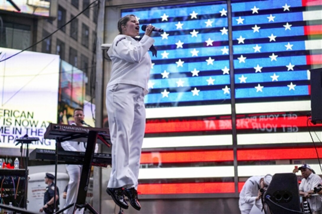 Navy Petty Officer 2nd Class Laura Carey sings lead vocals with "Rhode Island Sound" from Navy Band Northeast at a concert in Times Square during Fleet Week New York, May 23, 2015. Carey is a musician. The event provides an opportunity for residents of the city and surrounding areas to meet sailors, Marines and Coast Guardsmen, as well as see the latest capabilities of today's maritime services.