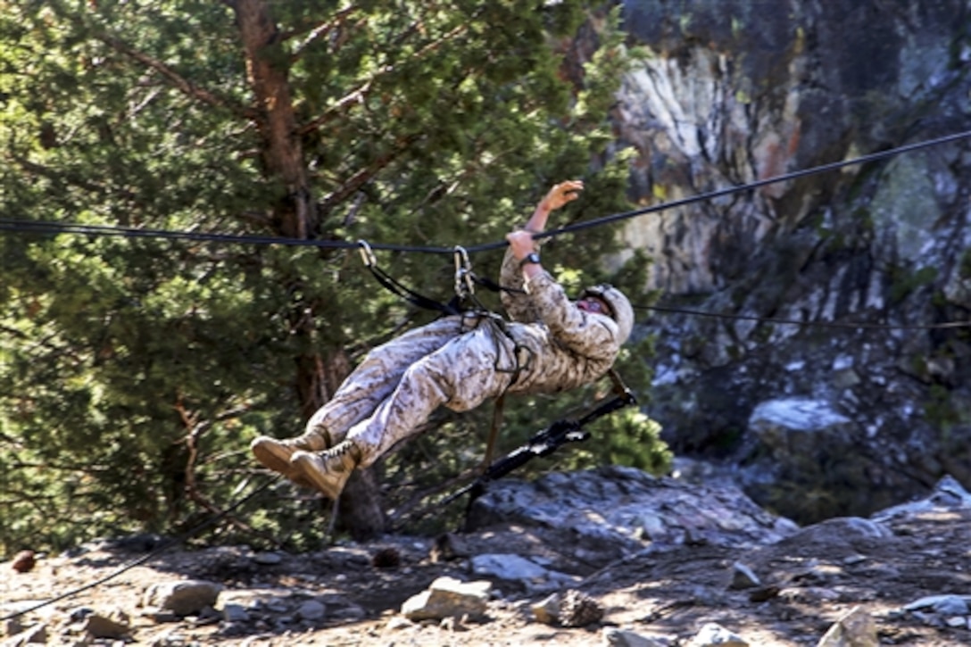 Marine Corps Lance Cpl. Maximilian Roth crosses a gorge on a rope during his final Marine Corps Operational Test and Evaluation Activity assessment at Marine Corps Mountain Warfare Training Center Bridgeport, Calif., May 18, 2015. Roth is a rifleman assigned to Alpha Company, Ground Combat Element Integrated Task Force.