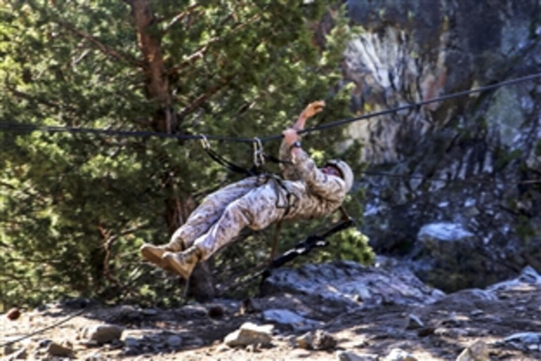 Marine Corps Lance Cpl. Maximilian Roth crosses a gorge on a rope during his final Marine Corps Operational Test and Evaluation Activity assessment at Marine Corps Mountain Warfare Training Center Bridgeport, Calif., May 18, 2015. Roth is a rifleman assigned to Alpha Company, Ground Combat Element Integrated Task Force. 