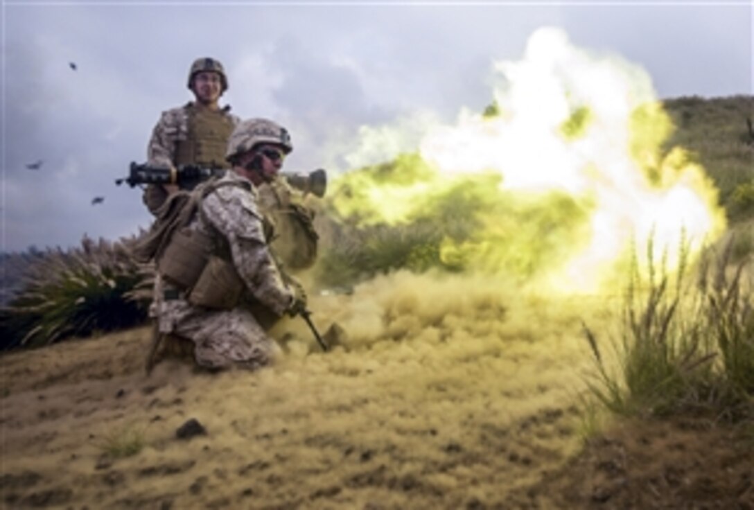 U.S. Marine Corps Private 1st Class Jonathan D. Eatman, front, and Sgt. Calum J. Boyes, standing, fire an AT-4 during a company-sized assault on Range 10 during Operation Lava Viper at Pohakuloa Training Area, Hawaii, May 21, 2015. 