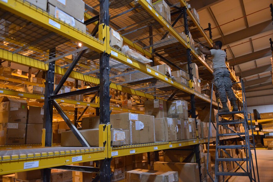 Senior Airman Jesse Guapi, 379th Expeditionary Logistics Squadron consolidated aircraft parts store, locates a specific aircraft part for an aircraft mechanic inside the consolidated aircraft parts store warehouse May 21, 2015 at Al Udeid Air Base, Qatar. Guapi is a native from Baltimore, Maryland and deployed out of Royal Air Force Lakenheath, England. (U.S. Air Force photo/Staff Sgt. Alexandre Montes)   