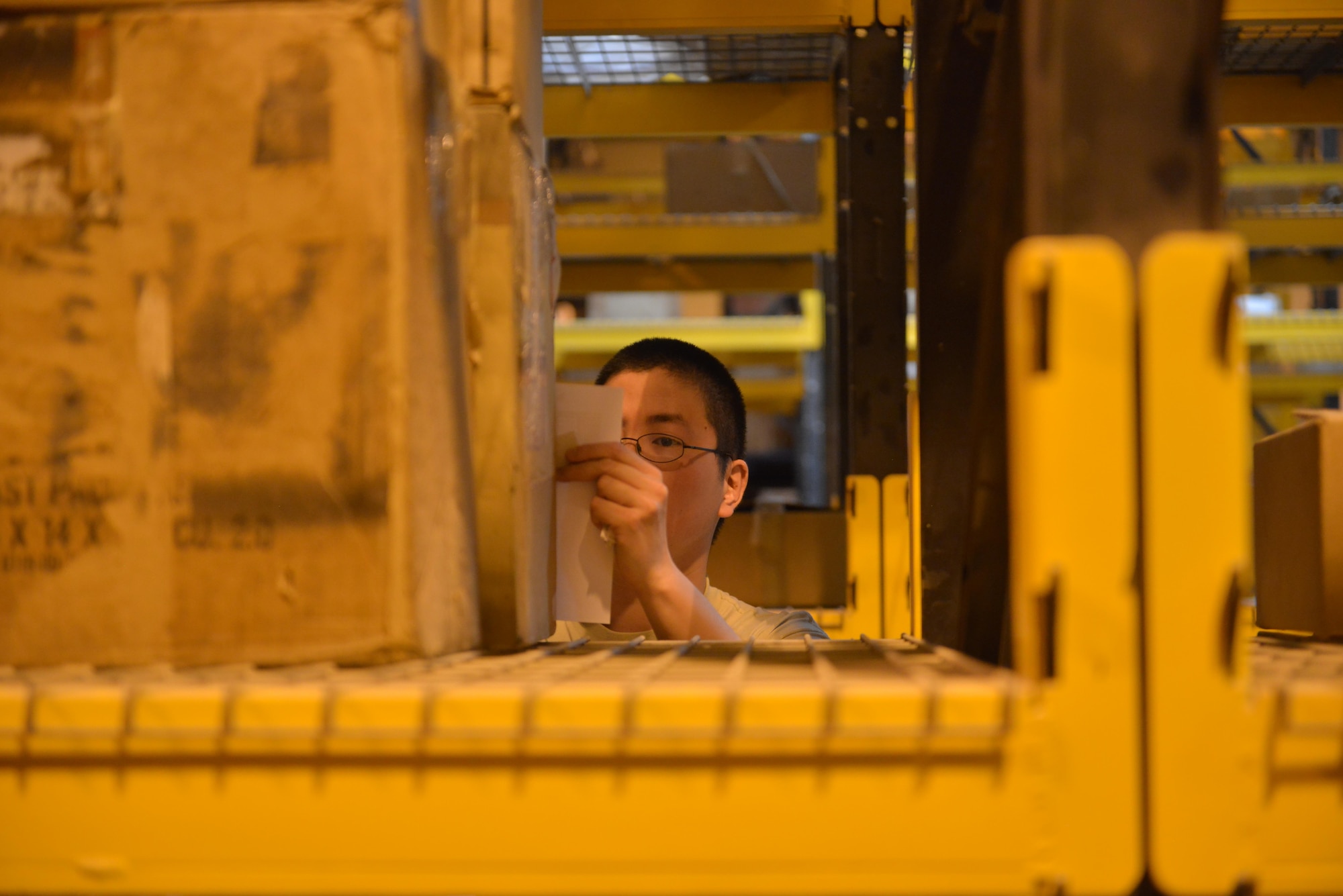 Senior Airman Joshua Louis, 379th Expeditionary Logistics Squadron consolidated aircraft parts store, locates aircraft parts that are considered out of date or that need to be repaired as part of a daily inventory May 21, 2015 at Al Udeid Air Base, Qatar. Louis is a native from Cleveland, Ohio and deployed out of Cannon Air Force Base, New Mexico. (U.S. Air Force photo/Staff Sgt. Alexandre Montes)     