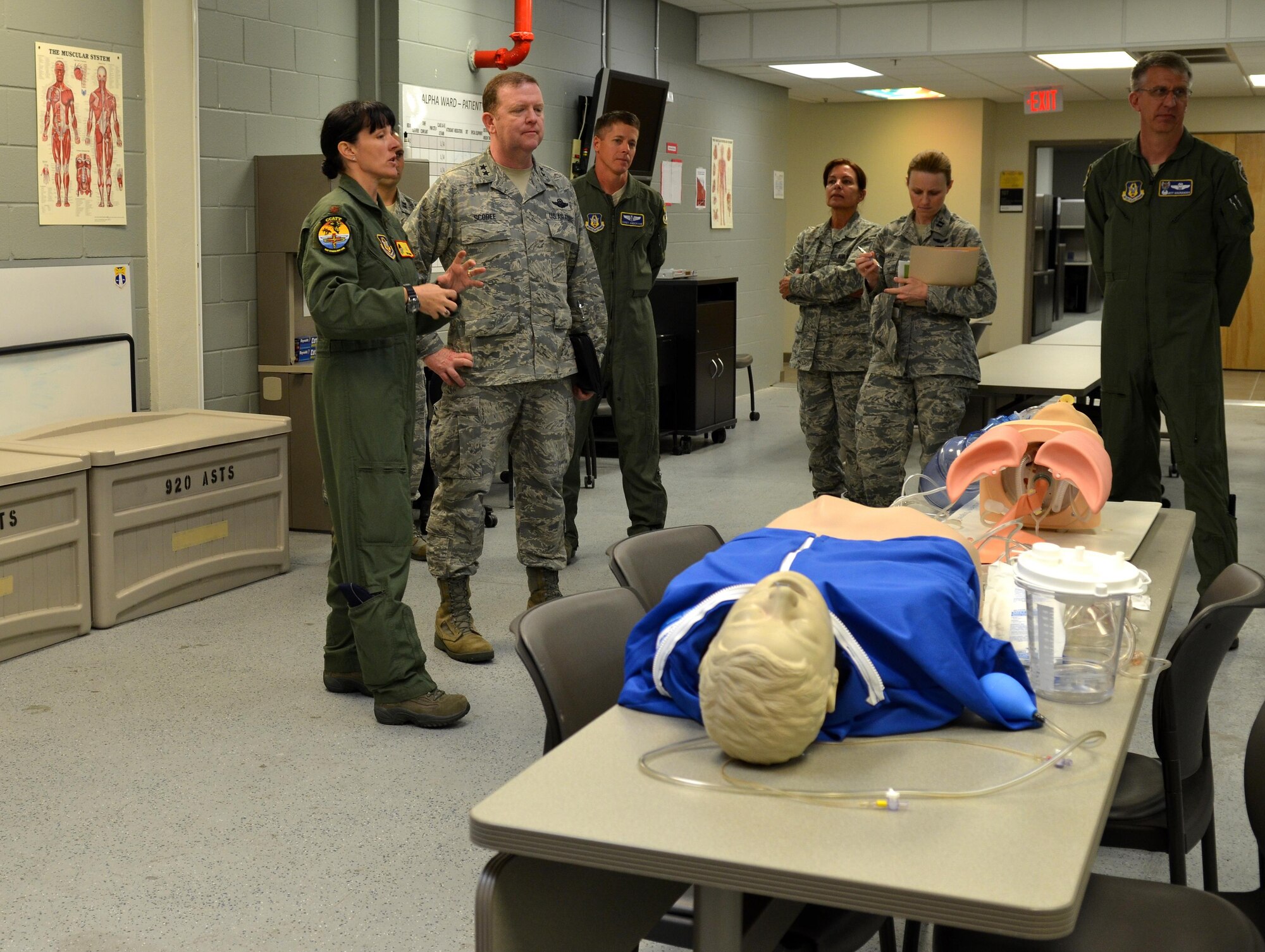 Maj. Trish Hayden (left), 920th Rescue Wing critical care air transport team, briefs Maj. Gen.  Richard Scobee, 10th Air Force commander, and Col. Jeff Macrander, 920th RQW commander (right), on the life-saving capabilities of the 920th RQW medical squadron. Scobee visited the Rescue Wing to familiarize himself with the missions and heroes of his rescue and special operations components. (Air Force photo/1st Lt. Leslie Forshaw)