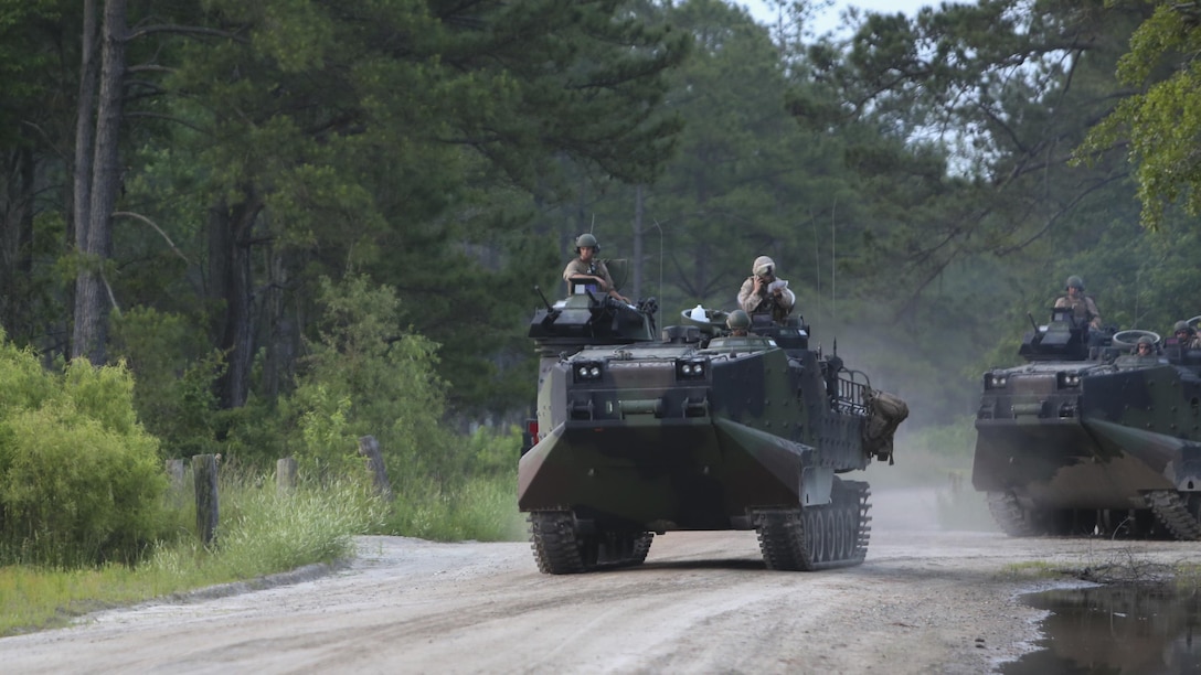 Assault amphibious vehicles with 2nd Assault Amphibian Battalion, 2nd Marine Division, move toward the unit’s objective during an obstacle-breaching exercise on Marine Corps Base Camp Lejeune, N.C., May 20, 2015. The exercise built camaraderie within the battalion and cooperation between 2nd AA Bn. and other units participating in the training.