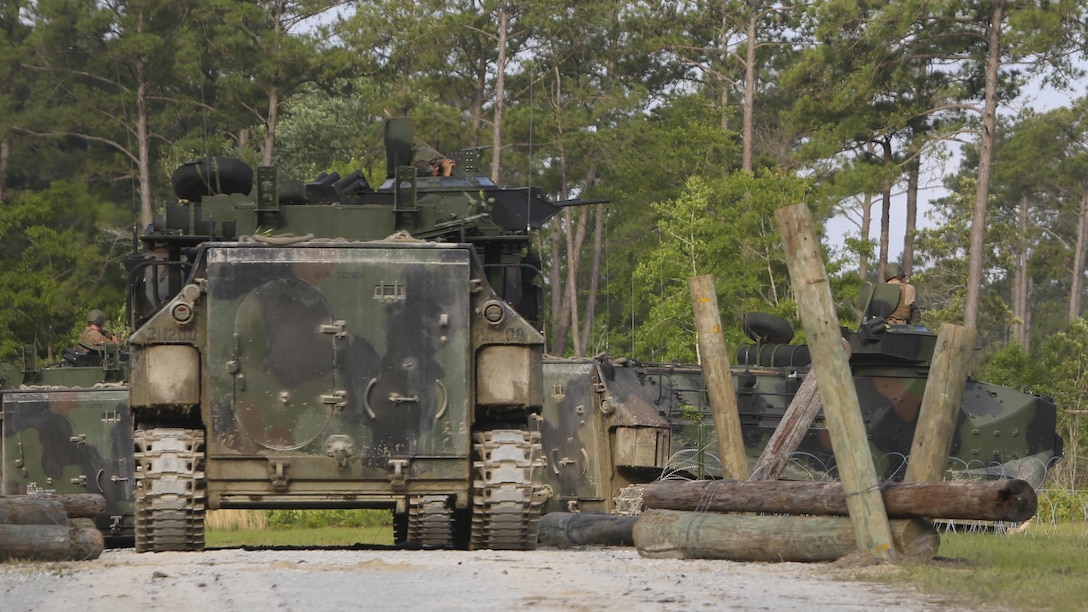 Assault amphibious vehicles with 2nd Assault Amphibian Battalion, 2nd Marine Division, provide security during an obstacle-breaching exercise on Marine Corps Base Camp Lejeune, N.C., May 20, 2015. The vehicles transported Marines with 2nd Combat Engineer Battalion to their objectives and gave communication support and extra firepower throughout the mission.