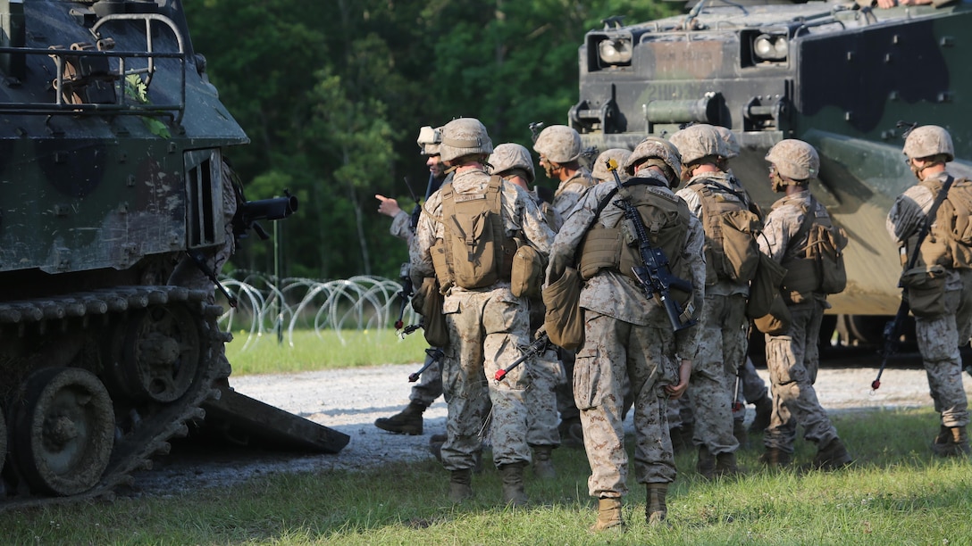 Marines with 2nd Combat Engineer Battalion, 2nd Marine Division, prepare to board an assault amphibious vehicle with 2nd Assault Amphibian Battalion during an obstacle-breaching exercise on Marine Corps Base Camp Lejeune, N.C., May 20, 2015. The Marines used 2nd AA Bn. for communication, fire support and transport to and from their objectives throughout the exercise.