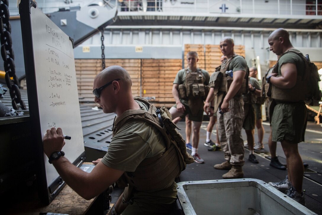 U.S. Marines with Kilo Company, Battalion Landing Team 3rd Battalion, 1st Marine Regiment, 15th Marine Expeditionary Unit, prepare to honor fallen service members during physical training aboard the USS Rushmore (LSD 47) at sea in the Pacific Ocean, May 25, 2015. In honor of Memorial Day, Marines with BLT 3/1 ran the ‘Memorial Day Murph’ challenge. The physical fitness event is named after Medal of Honor recipient U.S. Navy Lt. Michael P. Murphy. The challenge developed from Murphy’s daily work out routine, which consisted of a one-mile run, 100 pull-ups, 200 push-ups, 300 squats, and finishing with another one-mile run.  (U.S. Marine Corps photo by Sgt. Emmanuel Ramos/Released)