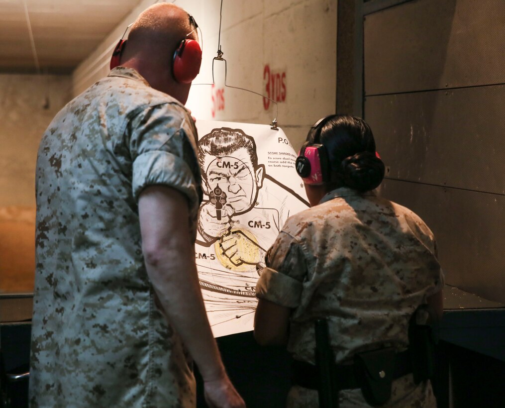 A guard with 1st Marine Corps District checks her score at Mitchel Field Shooting Complex after firing the M9A1 pistol on May 28. “They need to know how to apply deadly force with a weapon when necessary with threats we face on a day-to-day basis,” said Gunnery Sergeant William Neimi, guard chief of 1st Marine Corps District. The guards use the M9A1 pistol, Benelli M104 shotgun, and M16-A4 service rifle as their trained weapons.