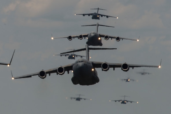 Members of the 437th Airlift Wing at Joint Base Charleston, S.C., conduct a multi-ship C-17 Globemaster III formation during Crescent Reach 15 on May 21, 2015. This exercise tested and evaluated Joint Base Charleston's ability to launch a large aircraft formation in addition to processing and deploying duty passengers and cargo in response to a simulated crisis abroad. (U.S. Air Force photo/Staff Sgt. Corey Hook)                                                                                                                                                                                                                                                                                                                                                                                                                                                                                                                                                                                       