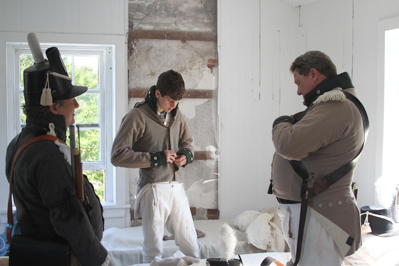 FORT NORFOLK, Va. -- War of 1812 reenactors dress in the fort's guardhouse June 9, 2012. The reenactors were part of OpSail 2012, which marked the bicentennial of the War of 1812 and brought international tall ships and naval vessels to Hampton Roads and other port cities.  (U.S. Army photo/Kerry Solan)