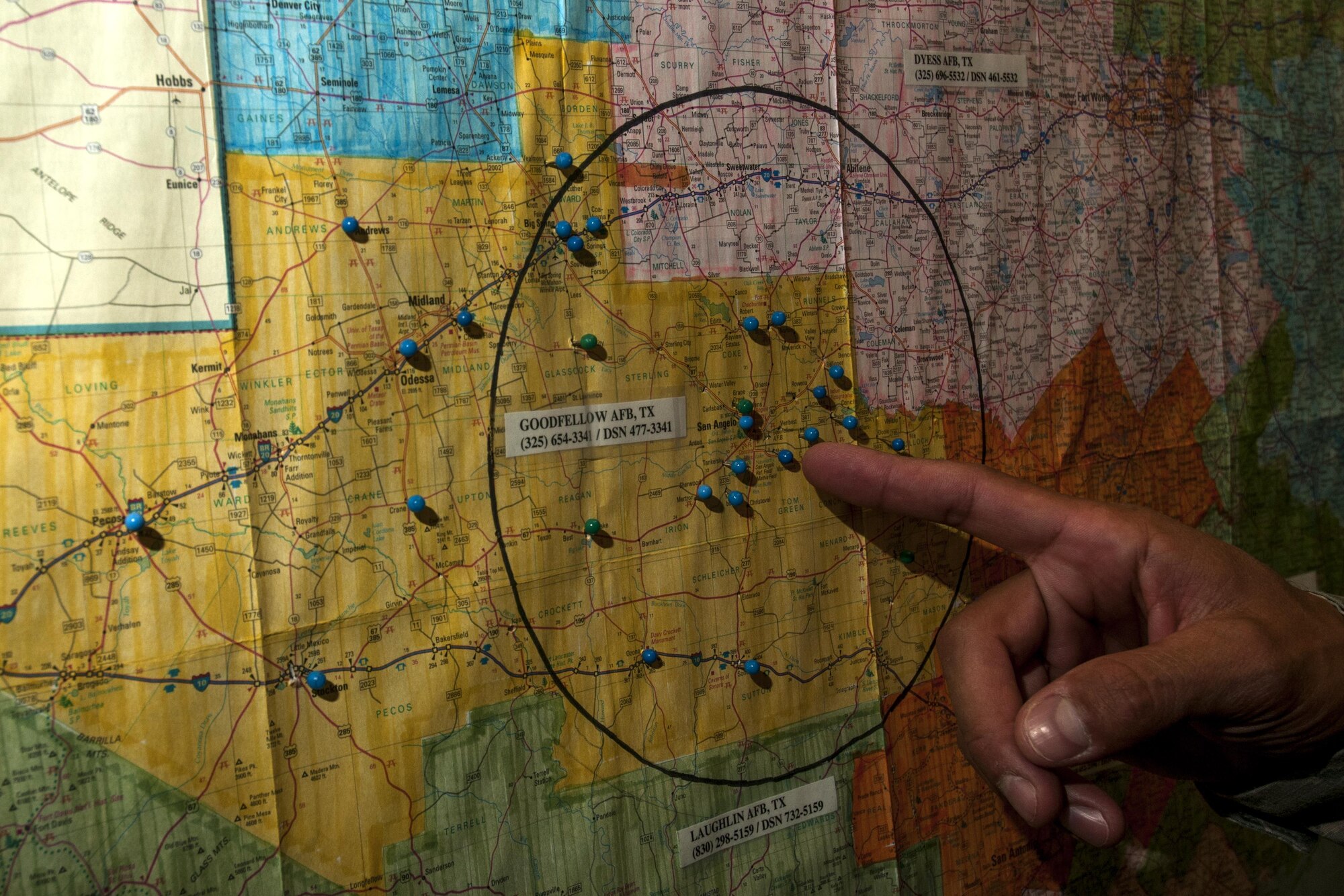 GOODFELLOW AIR FORCE BASE, Texas – Staff Sgt. Albert L. Hetrick, 17th Training Wing Honor Guard NCO in charge, illustrates his unit’s area of responsibility on a map at Heath Hall April 23. The yellow coloring, not the circle, depicts the region that the Honor Guard performs details. (U.S. Air Force photo/ Senior Airman Scott Jackson)