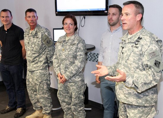 Col. Matthew Tyler, right, U.S. Army Corps of Engineers Europe District commander, officially welcomes home Forward Engineer Support Team-Advanced members (from left) Anton Klein, Master Sgt. John Walls, Maj. Michelle Dittloff and Jason Riharb during a function May 11 at the Amelia Earhart Center in Wiesbaden, Germany. The FEST-A recently wrapped up a six-month deployment to Liberia for Operation United Assistance, the U.S.-led effort to stop the spread of Ebola in West Africa.