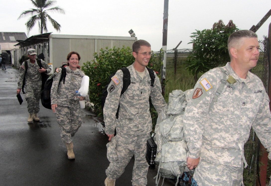 The remaining military members of U.S. Army Corps of Engineers Europe District's FEST-A team -- (from right) Sgt. 1st Class Will Land, then-1st. Lt. Willem Pretorius, Maj. Michelle Dittloff and Master Sgt. John Walls -- prepare to board a plane April 8 in Monrovia, Liberia, wrapping up their deployment for Operation United Assistance, the U.S. military mission to halt the spread of Ebola.