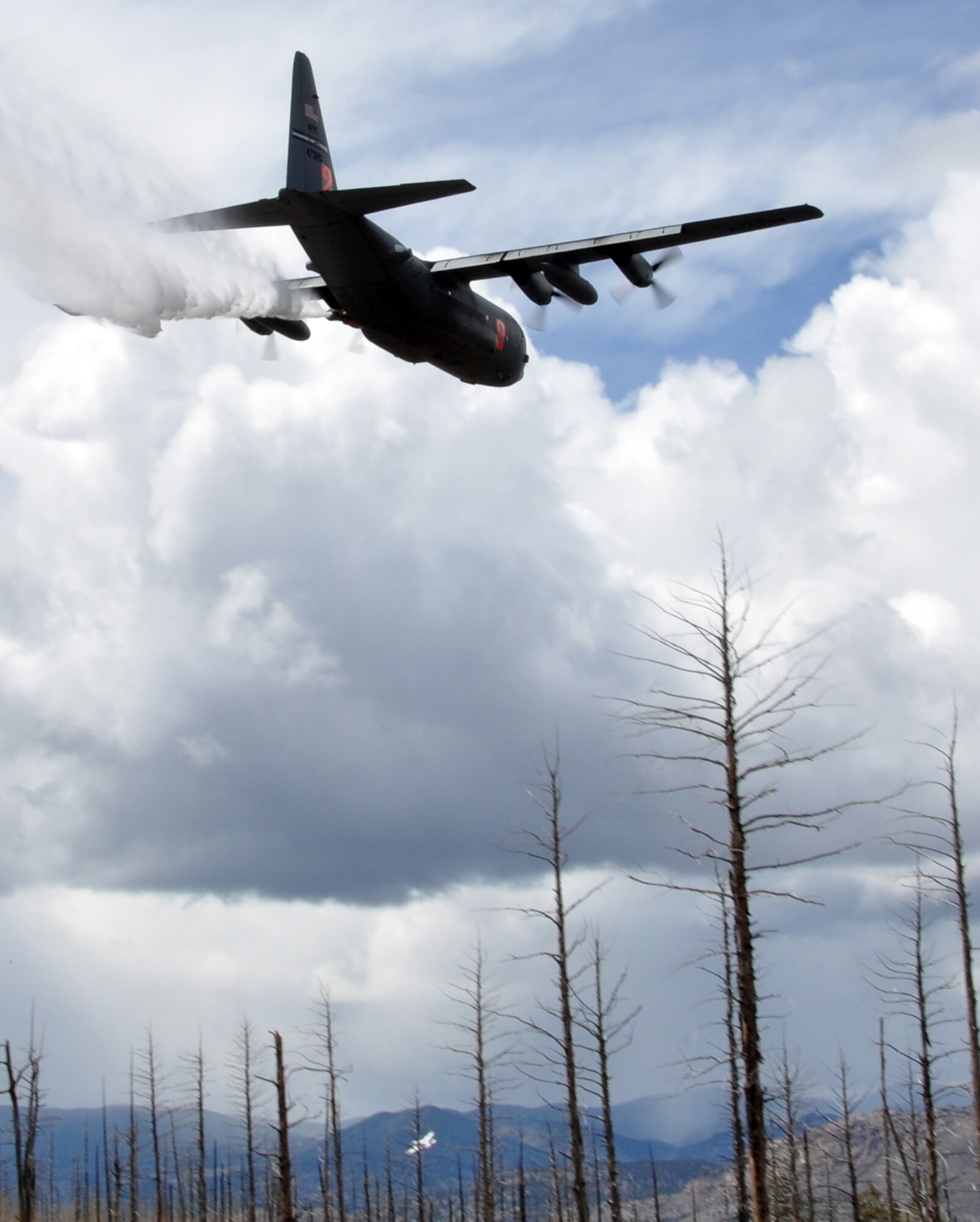 A Modular Airborne Fire Fighting System-equipped C-130 from the Air Force Reserve’s 302nd Airlift Wing drops potable water near Hackett mountain in Pike National Forest, Colo. during MAFFS certification training, May 16, 2015. Retardant dropped from a MAFFS-equipped C-130 can cover an area one-quarter of a mile long and 100 feet wide to aid in the containment of wildland fires. (U.S. Air Force photo/Master Sgt. Daniel Butterfield) 