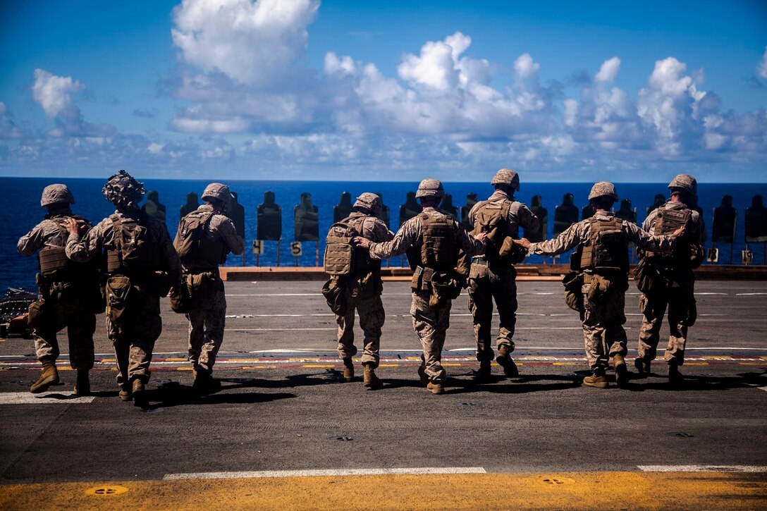 U.S. Marines with Lima Company, Battalion Landing Team 3rd Battalion, 1st Marine Regiment, 15th Marine Expeditionary Unit, fire and advance on their targets aboard the USS Essex (LHD 2) at sea in the Pacific Ocean, May 29, 2015. As part of the 15th MEU’s ground combat element, these Marines continue to enhance their combat skills in environments similar to those they may find in future missions. (U.S. Marine Corps photo by Cpl. Elize McKelvey/Released)