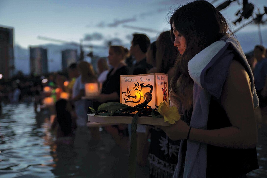 Families and friends of those who have passed away line up in the waters off of Magic Island at Ala Moana Beach Park with decorated lanterns to release for the Lantern Floating Hawaii ceremony held May 25, 2015. A local Buddhist sect of Shinnyo-en has organized the Memorial Day event since it first stared in 1999. (U.S. Marine Corps photo by Cpl. Brittney Vella/Released)