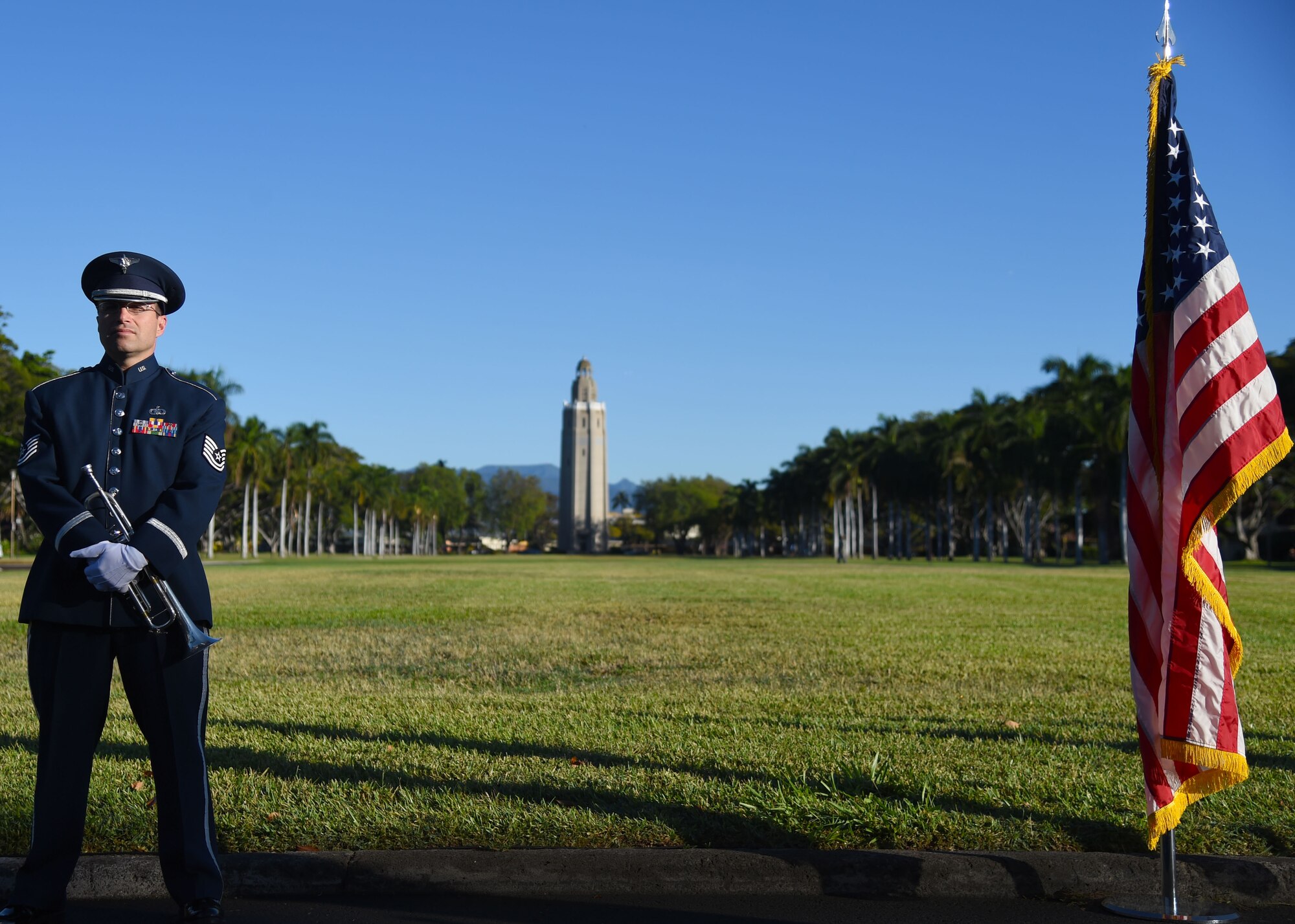 Tech. Sgt. David Diamond, a musician from the Band of the Pacific-Hawaii, stands in front of the Freedom Tower during a ceremony commemorating the 80th anniversary of Hickam Field’s dedication on Joint Base Pearl Harbor-Hickam, Hawaii, May 29, 2015. Lt. Col. Horace Hickam received the Silver Star for gallantry under fire in the Mexican state of Chihuahua on April 22, 1916. Hickam, a pioneer military aviator, died after crashing his Curtiss A-12 Shrike on November 5, 1934 while conducting night landings on an unlighted runway at Fort Crockett, Texas. On May 31, 1935 ground was broken at Hickam Field after being designated by the war department in Washington D.C. on May 21, 1935. (U.S. Air Force photo by Tech. Sgt. Aaron Oelrich/Released)