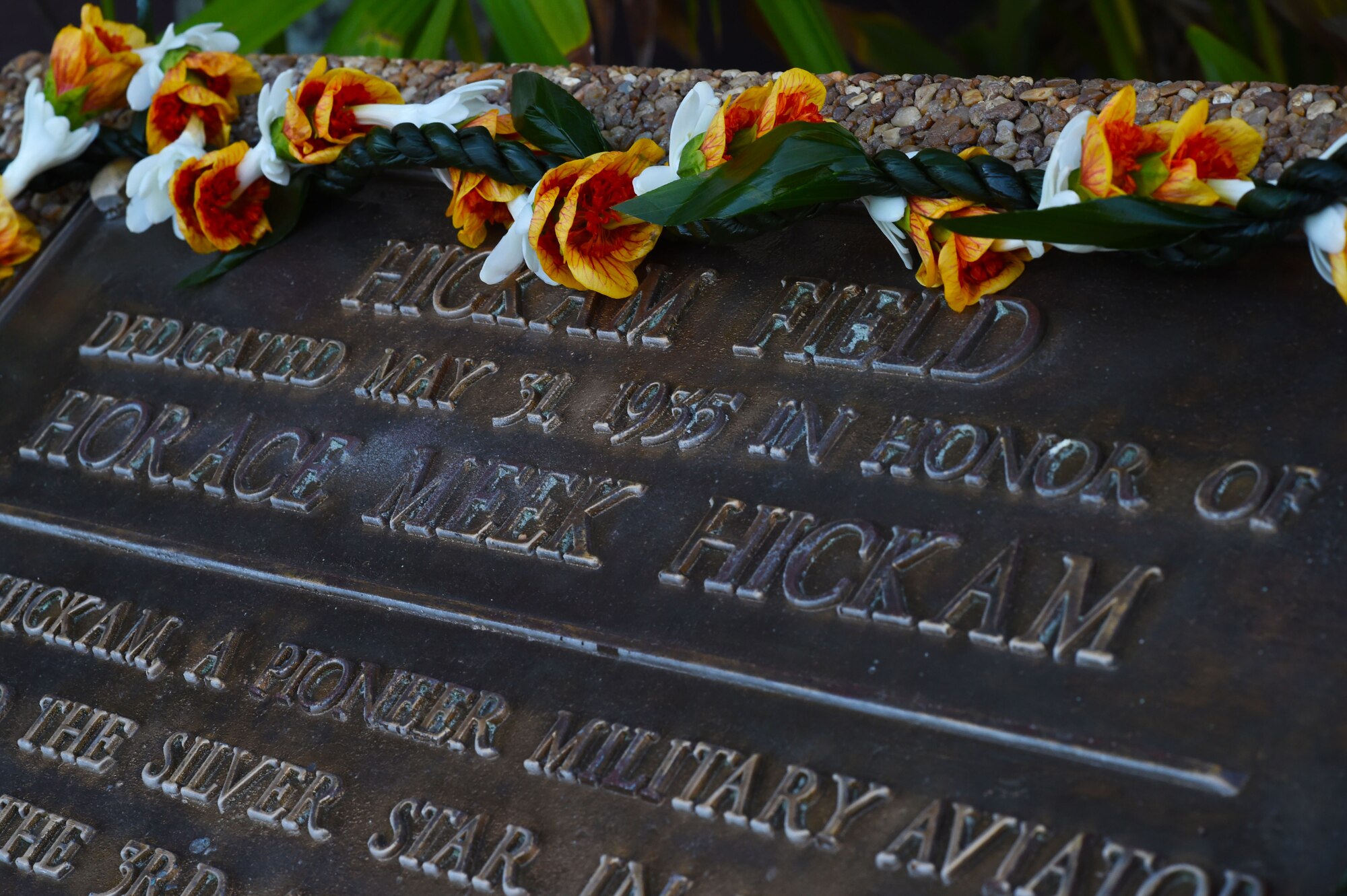A lei, made from Hawaiian Ti, Elena and tuberose flowers, and symbolizing affection, endearment and respect, rests on the plaque during a ceremony commemorating the 80th anniversary of Hickam Field’s dedication on Joint Base Pearl Harbor-Hickam, Hawaii, May 29, 2015. On  May 21,1935, the war department in Washington D.C. issued General Orders No. 4 designating the Hawaiian flying field as “Hickam Field” in honor of Lt. Col. Horace Meek Hickam. Hickam died the previous year on Nov. 5, 1934 in an aircraft accident at Fort Crockett, Texas. Ground was broken at Hickam Field on May 31, 1935. (U.S. Air Force photo by Tech. Sgt. Aaron Oelrich/Released)