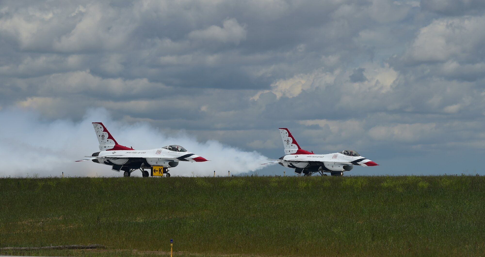 Two Thunderbirds await take-off on the tarmac May 29, 2015 on Buckley Air Force Base, Colo. The Thunderbirds are staging out of Buckley AFB for the up-coming Rocky Mountain Air Show. (U.S. Air Force photo by Airman 1st Class Luke W. Nowakowski/Released)  
