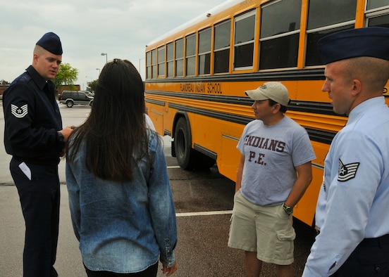 Tech Sgts. Bo Ellefson and Brian Johnson, 114th Fighter Wing recruiters, welcome students and head teacher Chi Tran from the Flandreau Indian School Summer Academy to the 114th Fighter Wing in Sioux Falls, S.D., May 29, 2015. The students toured the 114th FW and were briefed about the many roles and specialized fields that make up the South Dakota Air National Guard.(National Guard photo by Staff Sgt. Luke Olson/Released)