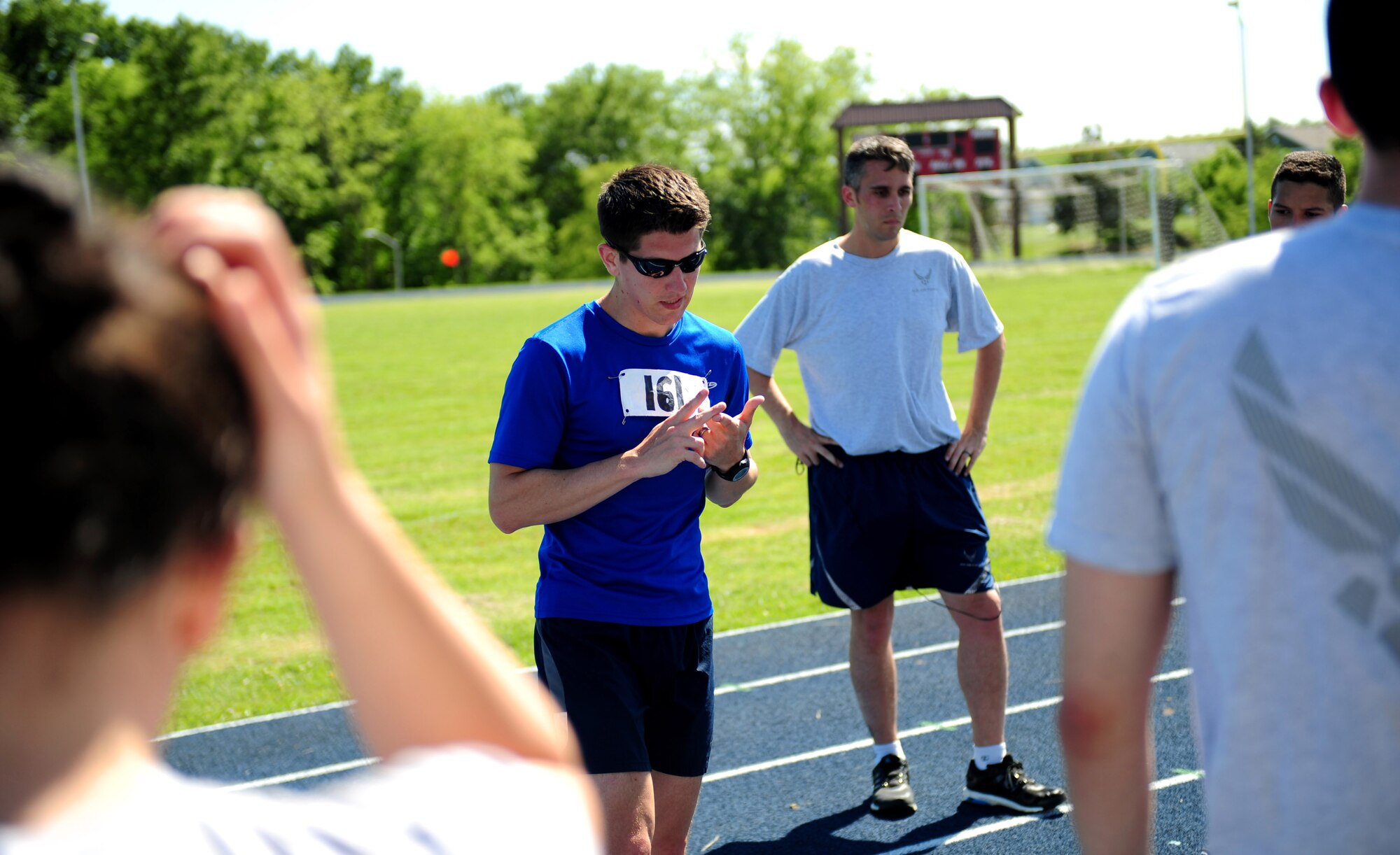 U.S. Air Force Staff Sgt. Brendan Brustad, 509th Medical Support Squadron NCO in charge of medical contracting, shares a few words after completing his 161-mile run at Whiteman Air Force Base, Mo., May 21, 2015. Brustad’s co-workers from the 509th MDSS joined him for the final stretch of his run. (U.S. Air Force photo by Senior Airman Joel Pfiester/Released)