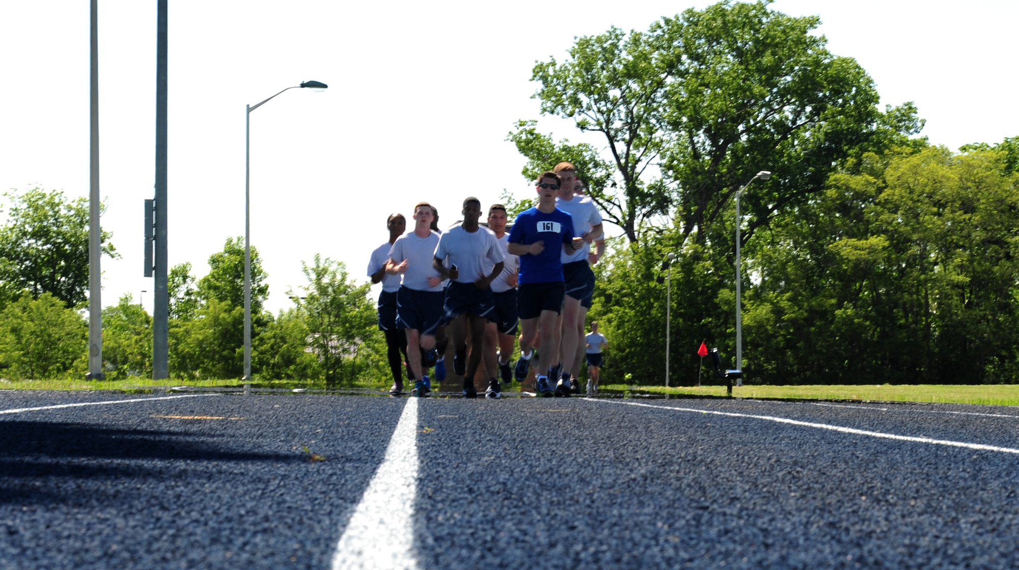 U.S. Air Force Staff Sgt. Brendan Brustad along with his co-workers from the 509th Medical Support Squadron run the final stretch of Brustad’s 161-mile run at Whiteman Air Force Base, Mo., May 21, 2015. Brustad ran approximately 26 miles a day for six days to honor the victims of the 2011 Joplin, Mo. tornado. (U.S. Air Force photo by Senior Airman Joel Pfiester/Released)