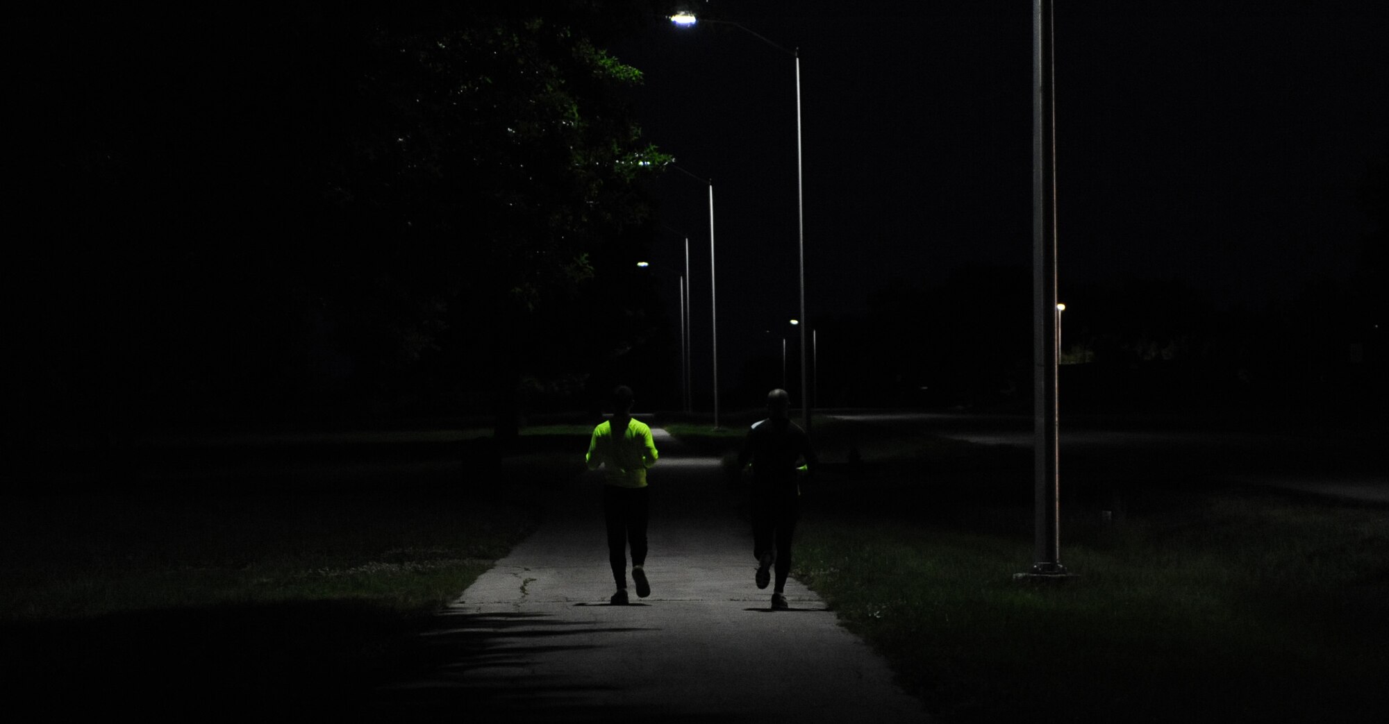 U.S. Air Force Staff Sgt. Brendan Brustad and 1st Lt. James Laughridge, both from the 509th Medical Support Squadron, run during the early hours of the day at Whiteman Air Force Base, Mo., May 19, 2015. The Joplin Memorial Run is an annual event where participants can register to run a half-marathon or a 5K. Brustad registered for the run but rather than running the distance, he ran 161 miles over the course of six days, all on Whiteman Air Force Base. (U.S. Air Force photo by Senior Airman Joel Pfiester/Released)
